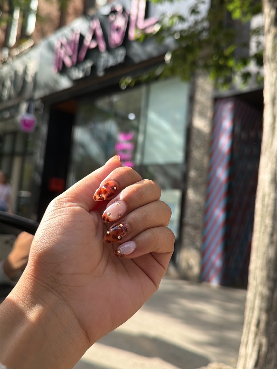 Burgundy nail art photographed outside the salon