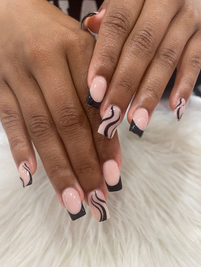 Black French manicure with flowing swirl art
